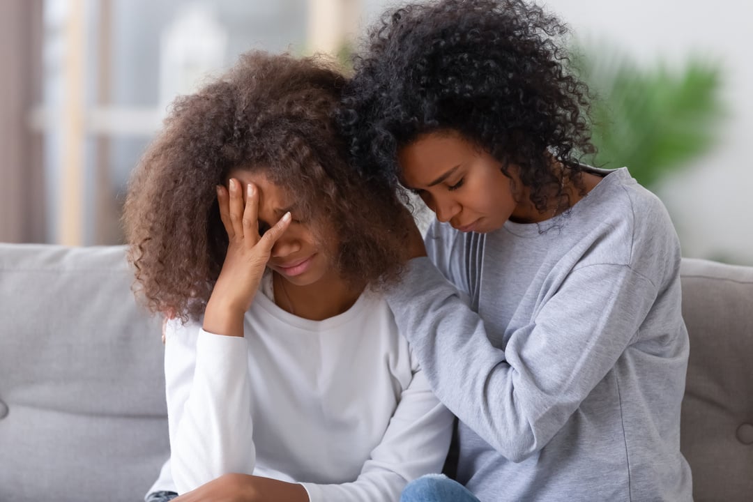 Upset african american mom hugging sad teen girl consoling supporting